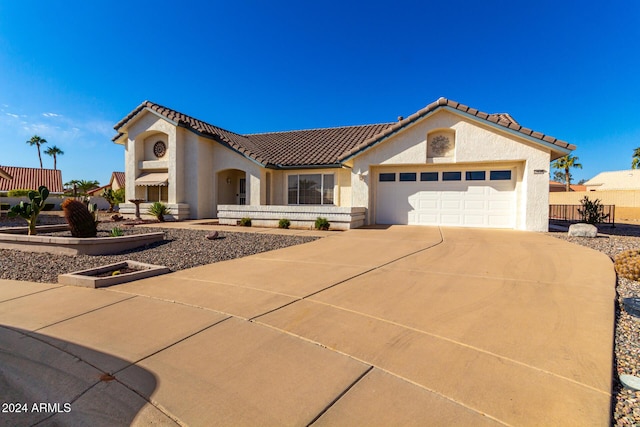 mediterranean / spanish home featuring a garage