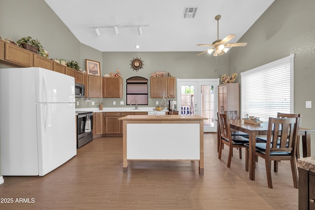 kitchen featuring light countertops, high vaulted ceiling, a ceiling fan, and stainless steel appliances