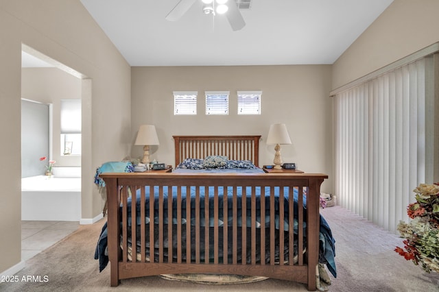 bedroom with ensuite bathroom, carpet flooring, and ceiling fan