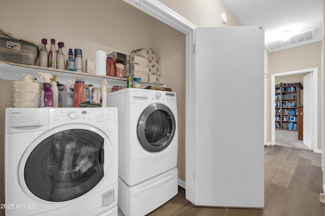 laundry room with independent washer and dryer, laundry area, and wood finished floors