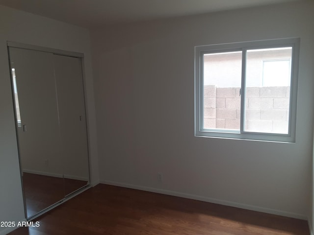 12205 N 41st Ln, Phoenix, AZ 85029 - unfurnished bedroom featuring dark wood-type flooring and a closet