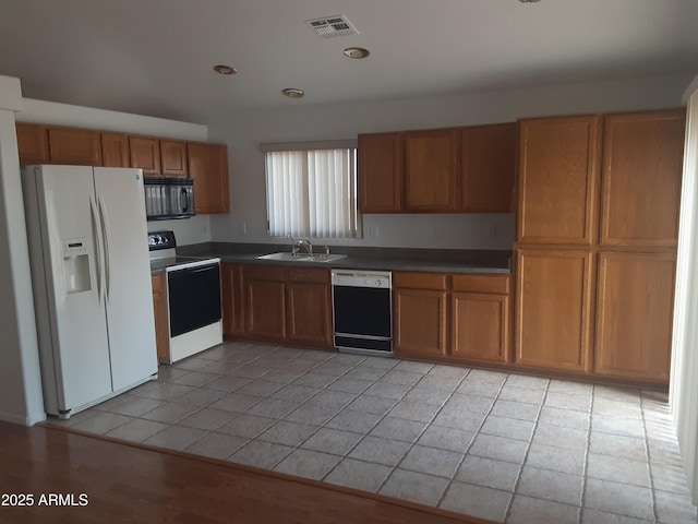 12205 N 41st Ln, Phoenix, AZ 85029 - kitchen featuring white refrigerator with ice dispenser, dishwashing machine, range with electric cooktop, black microwave, and light tile patterned floors