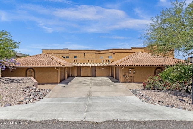 15834 E Sunflower Dr Unit 2, Fountain Hills, AZ 85268 - view of front facade featuring an attached garage, stucco siding, a tiled roof, and concrete driveway