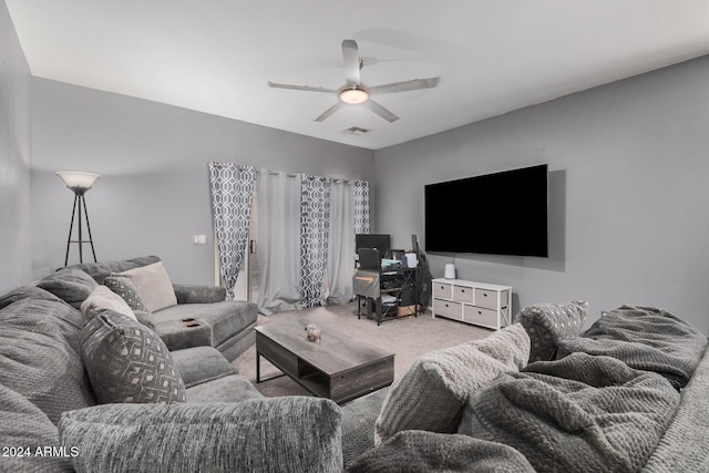 carpeted living room with ceiling fan