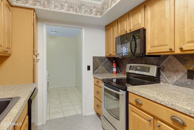 kitchen with backsplash, light brown cabinets, light tile patterned floors, and appliances with stainless steel finishes