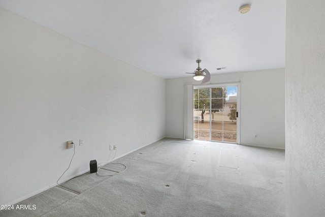 empty room featuring ceiling fan and light carpet