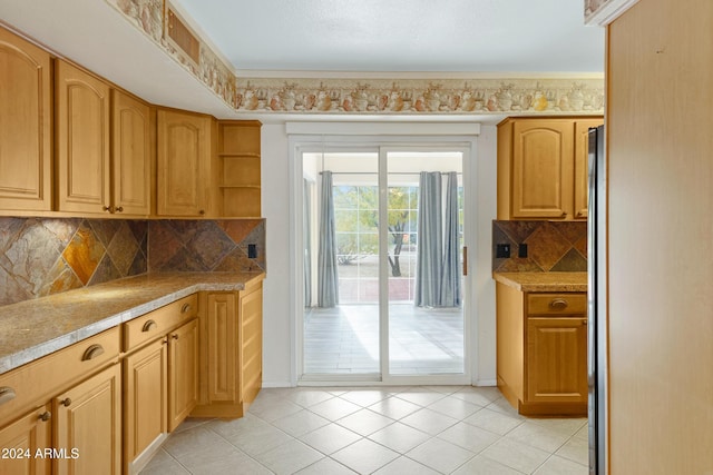 kitchen featuring tasteful backsplash and light tile patterned floors