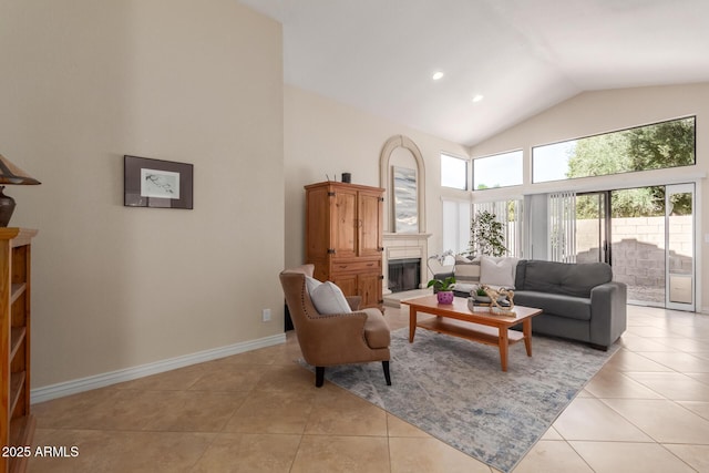 living area featuring a fireplace with raised hearth, baseboards, light tile patterned floors, recessed lighting, and high vaulted ceiling