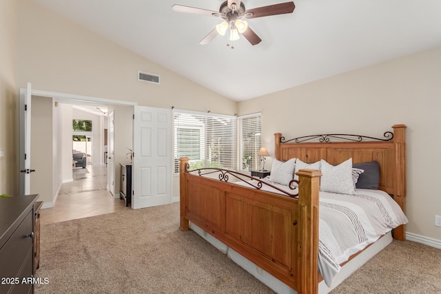 bedroom featuring light tile patterned floors, visible vents, ceiling fan, vaulted ceiling, and light carpet