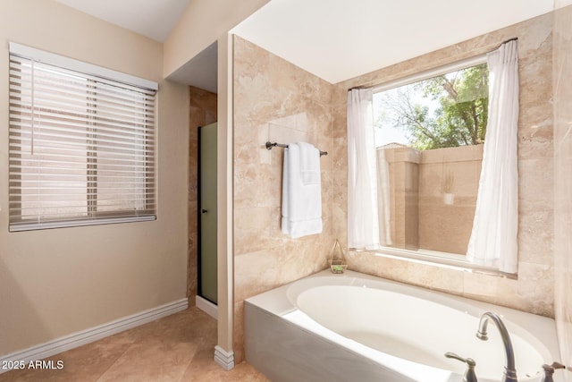 bathroom with tile patterned floors, baseboards, a shower with shower door, and a bath