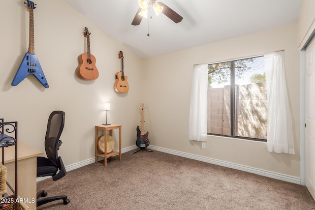 unfurnished office featuring baseboards, carpet floors, lofted ceiling, and ceiling fan