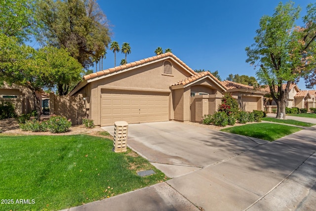 view of front of property with a tiled roof, concrete driveway, a front yard, stucco siding, and a garage