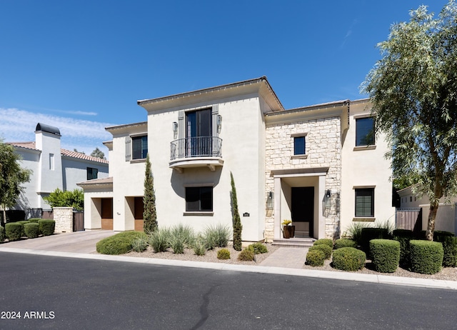 view of front of home with a balcony and a garage