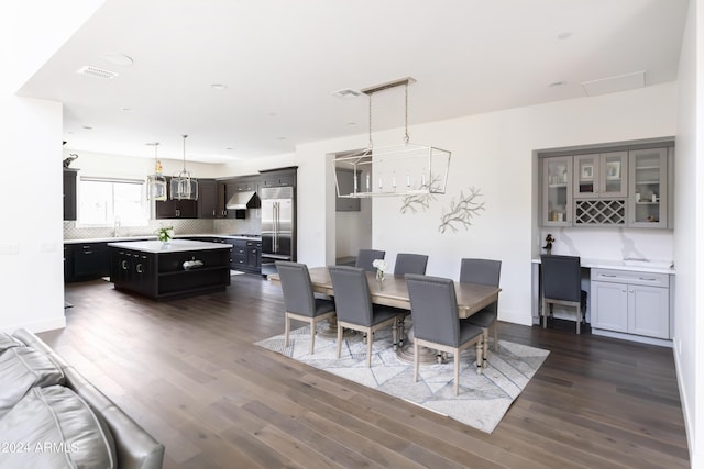 dining room with sink and dark wood-type flooring