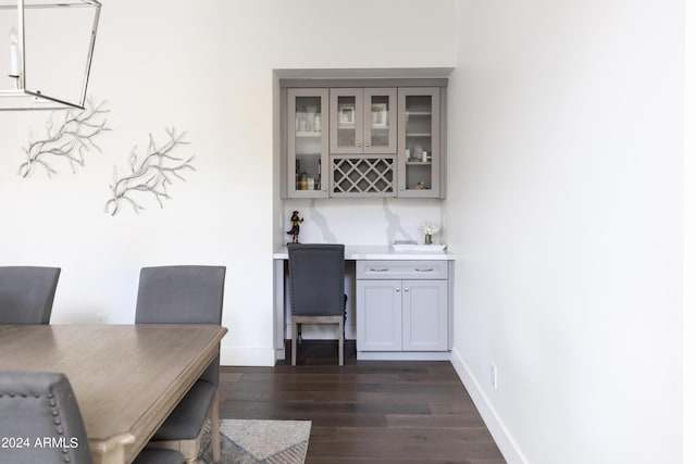 interior space featuring gray cabinetry, dark hardwood / wood-style flooring, and tasteful backsplash