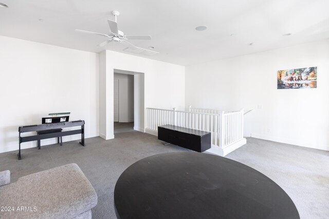 sitting room featuring light carpet and ceiling fan