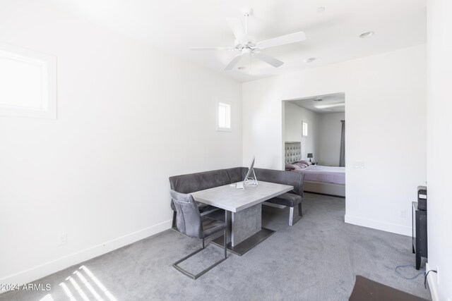 carpeted dining room featuring ceiling fan