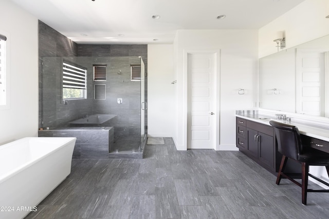 bathroom with separate shower and tub and vanity