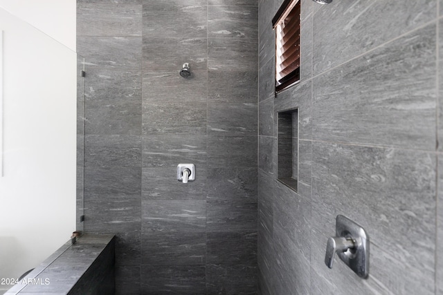 bathroom with tiled shower