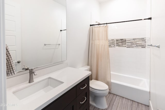 full bathroom featuring shower / tub combo, vanity, and toilet