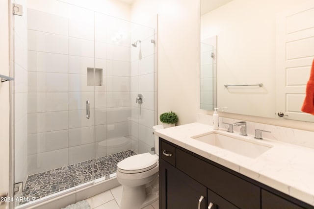 bathroom featuring an enclosed shower, vanity, toilet, and tile patterned flooring