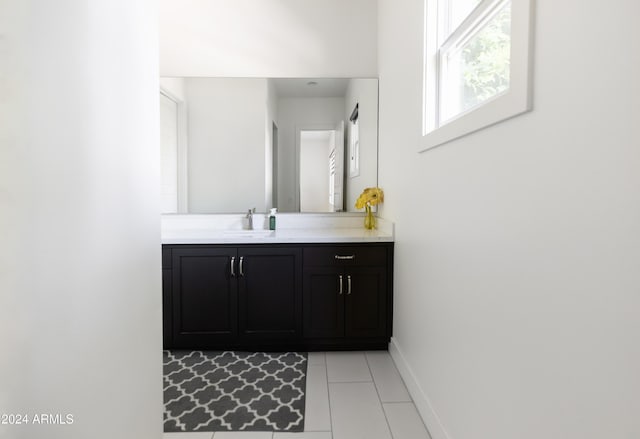 bathroom with tile patterned flooring and vanity