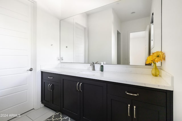 bathroom with tile patterned floors and vanity