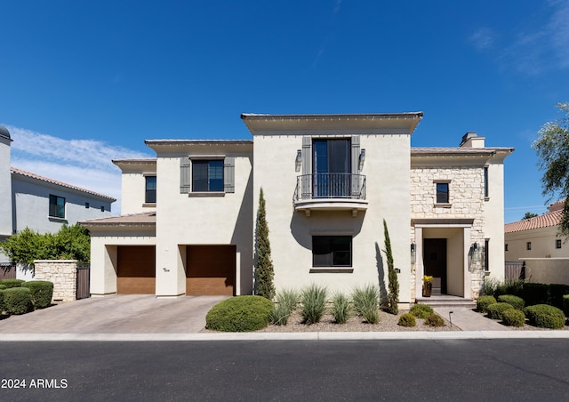 view of front of home featuring a balcony and a garage