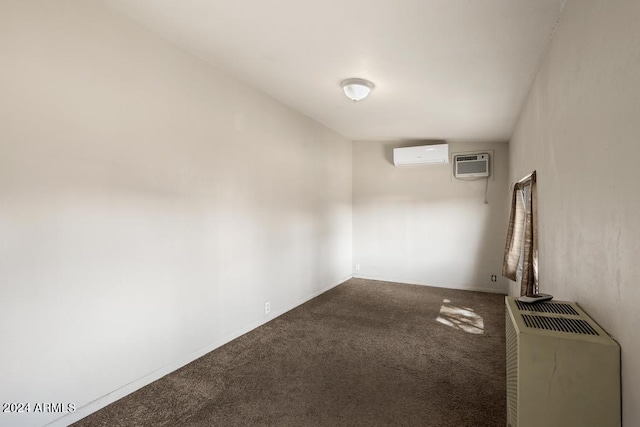 carpeted spare room with a wall unit AC