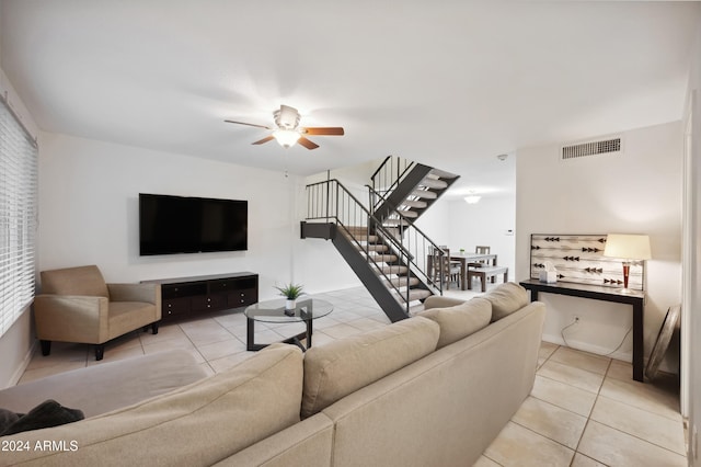 living room with ceiling fan and light tile patterned floors