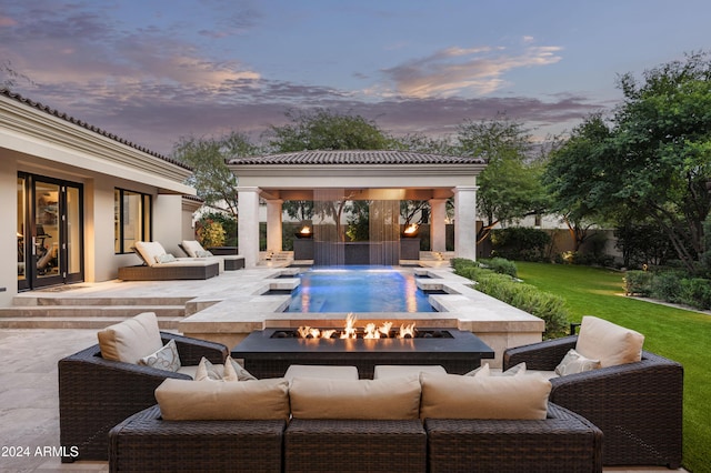 exterior space featuring a patio, pool water feature, an outdoor living space with a fire pit, and a lawn