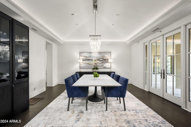 dining room featuring french doors, a raised ceiling, and dark wood-type flooring