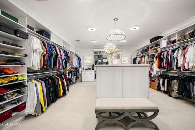 walk in closet with light colored carpet