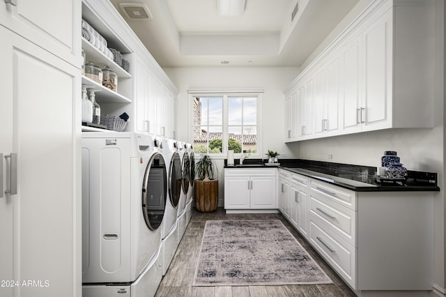 laundry room with washer and clothes dryer, cabinets, and sink