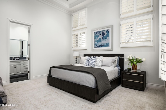 carpeted bedroom with a towering ceiling, connected bathroom, and crown molding