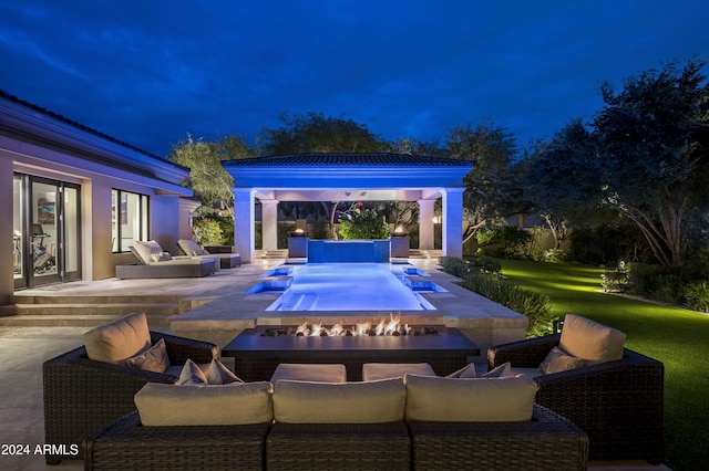 view of pool with a fire pit, a patio area, and a lawn