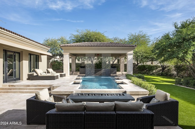 exterior space featuring a lawn, pool water feature, a patio, and an outdoor hangout area