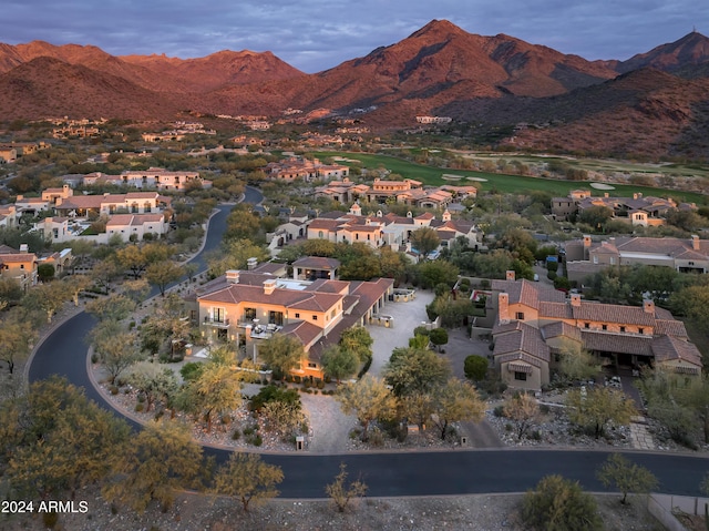 aerial view at dusk featuring a mountain view