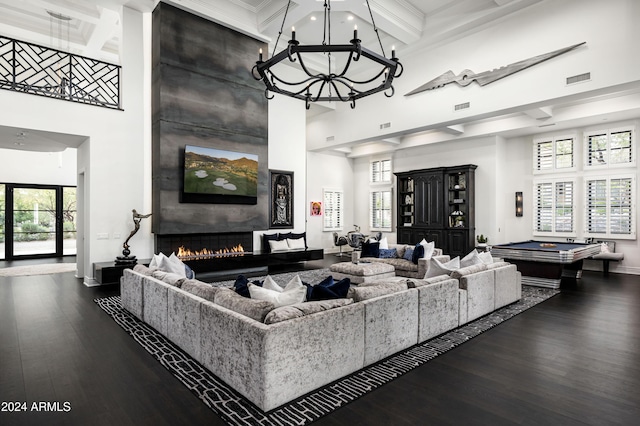 living room featuring billiards, a towering ceiling, a fireplace, beamed ceiling, and plenty of natural light