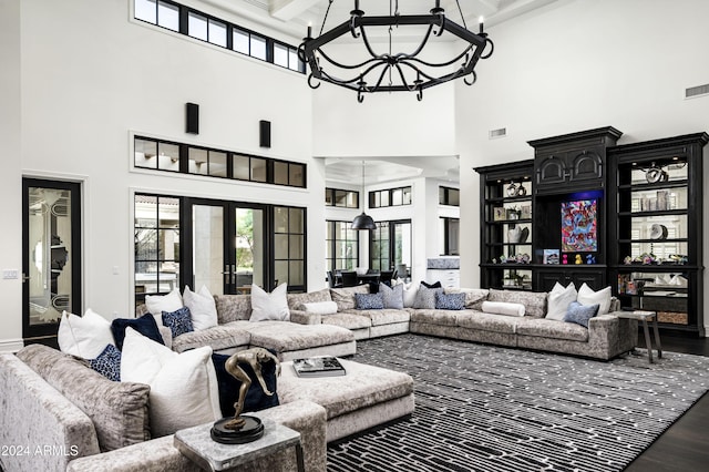 living room with french doors and a towering ceiling