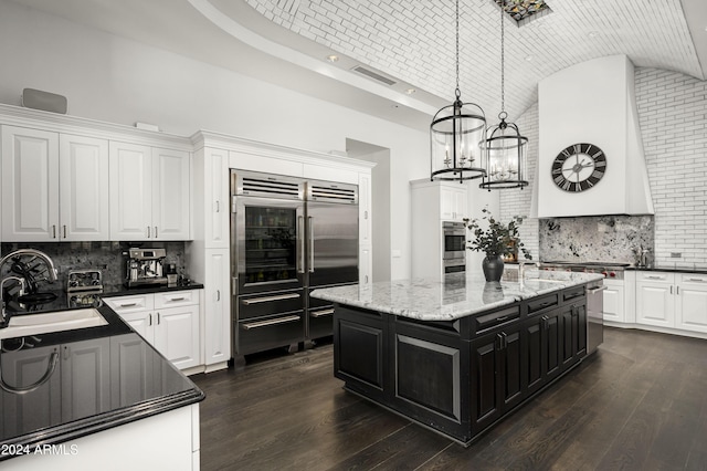 kitchen with decorative light fixtures, white cabinetry, brick ceiling, and stainless steel appliances