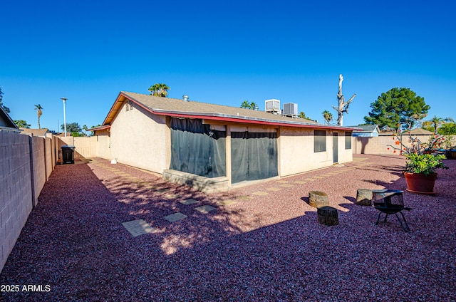 rear view of property featuring central AC unit