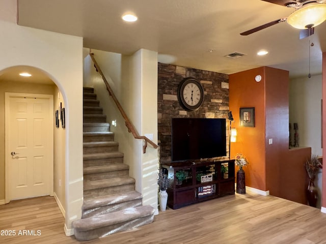 3935 E Rough Rider Rd Unit 1066, Phoenix, AZ 85050 - living room with wood finished floors, a ceiling fan, stairway, arched walkways, and recessed lighting