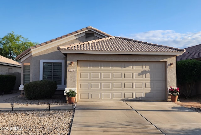 single story home featuring a tile roof, a garage, stucco siding, and driveway