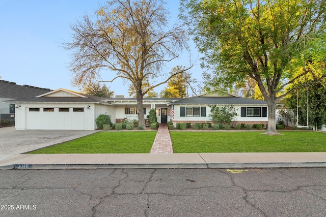 single story home with a garage and a front yard