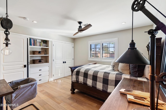 bedroom with ceiling fan and light hardwood / wood-style floors