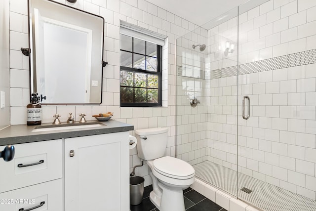 bathroom featuring tile walls, vanity, tasteful backsplash, toilet, and walk in shower