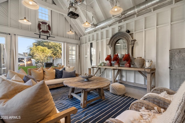 sunroom featuring vaulted ceiling with beams