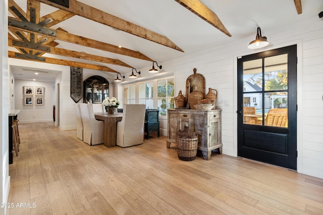 entryway featuring lofted ceiling with beams, plenty of natural light, and light hardwood / wood-style floors