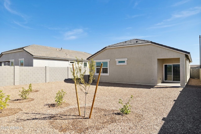 back of house featuring a fenced backyard, stucco siding, a tile roof, central air condition unit, and a patio area